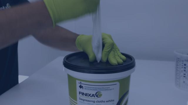 Degreasing cloths in dispenser bucket